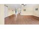 Open concept living room with hardwood floors and neutral-colored walls at 200 El Camino Dr # 402, Winter Haven, FL 33884