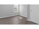 Image of a bedroom with a door, wood-style flooring, blinds, and light gray walls at 204 Brooks Rd, Frostproof, FL 33843