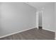 Gray walls and wood-style flooring in empty bedroom with view to another room at 204 Brooks Rd, Frostproof, FL 33843