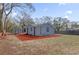 Charming home exterior featuring a gray siding, matching shed, and spacious yard at 204 Brooks Rd, Frostproof, FL 33843