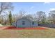 Charming home exterior featuring gray siding, a matching shed, and spacious backyard at 204 Brooks Rd, Frostproof, FL 33843