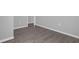 Flooring image showing light gray walls with white baseboards and wood style flooring at 204 Brooks Rd, Frostproof, FL 33843