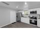 Modern kitchen featuring white cabinets, stainless steel appliances, and wood-look floors at 204 Brooks Rd, Frostproof, FL 33843