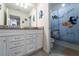 Bathroom with white cabinets, granite countertop, tile flooring and shower with a Nemo themed shower curtain at 207 Jetty Way, Davenport, FL 33897