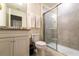 Bathroom with white cabinets, granite countertop and walk-in shower at 207 Jetty Way, Davenport, FL 33897