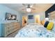 Bedroom with ceiling fan, TV and comfortable bed at 207 Jetty Way, Davenport, FL 33897