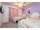 Bedroom featuring two twin beds with princess bedding, sheer pink curtains and a ceiling fan at 207 Jetty Way, Davenport, FL 33897