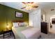 Bedroom featuring hardwood bed frame, closet, ceiling fan and wall art at 207 Jetty Way, Davenport, FL 33897