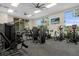 Community gym featuring modern exercise equipment, ceiling fans, and ample natural light from the large windows at 207 Jetty Way, Davenport, FL 33897