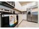 Modern kitchen featuring stainless steel appliances, granite countertops, white cabinetry, and tile backsplash at 207 Jetty Way, Davenport, FL 33897