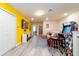 Game room with a large television, comfortable sofa, arcade game, and bright yellow accent wall at 207 Jetty Way, Davenport, FL 33897