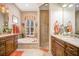 This luxurious bathroom features dual vanities, a soaking tub, and a separate shower at 210 Laurel Park Ct, Winter Park, FL 32792