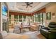 Inviting living room with fireplace, tray ceiling, and many windows for natural light at 210 Laurel Park Ct, Winter Park, FL 32792