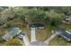 This aerial view shows a charming single-story home with a long driveway on a lush lot at 212 Glenn St, Leesburg, FL 34748