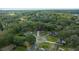 Aerial view of a residential neighborhood with mature trees and well-maintained homes at 212 Glenn St, Leesburg, FL 34748