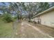 Backyard view with partial fence and open access at 212 Glenn St, Leesburg, FL 34748