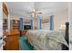 A cozy carpeted bedroom with curtains, a wooden dresser, and bookshelf at 212 Glenn St, Leesburg, FL 34748