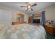 Bedroom featuring a ceiling fan, natural light, wood floors, full size bed, and side tables at 212 Glenn St, Leesburg, FL 34748