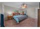 Inviting bedroom featuring a ceiling fan, side tables with lamps, and a cozy carpet at 212 Glenn St, Leesburg, FL 34748