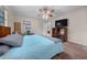 Carpeted bedroom featuring a ceiling fan, window and entertainment center with a TV at 212 Glenn St, Leesburg, FL 34748