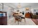 Cozy dining area with sliding glass doors, tile flooring, and traditional chandelier at 212 Glenn St, Leesburg, FL 34748