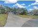 Long driveway with a large front yard and a well-maintained single-story home at 212 Glenn St, Leesburg, FL 34748