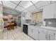 Bright kitchen area with white cabinetry and view into the dining area at 212 Glenn St, Leesburg, FL 34748