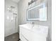 Bathroom vanity with illuminated mirror and sleek faucet, complemented by a modern shower at 213 James Dr, Winter Garden, FL 34787