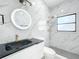 Renovated bathroom featuring modern fixtures, a gold rain shower head, and marble tiling at 213 James Dr, Winter Garden, FL 34787