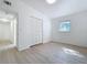 This bedroom features neutral walls, wood-look floors, a closet, and a bright window at 213 James Dr, Winter Garden, FL 34787