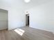 Bright bedroom features a closet, light wood-look flooring, neutral walls, and ample natural light at 213 James Dr, Winter Garden, FL 34787