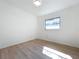 Bright bedroom with wood-look flooring and a large window at 213 James Dr, Winter Garden, FL 34787