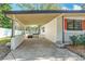 Carport of single-story home leads to enclosed backyard with well-maintained fence at 213 James Dr, Winter Garden, FL 34787