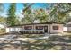 Inviting single-story home with brick walkway, carport, and manicured front yard at 213 James Dr, Winter Garden, FL 34787