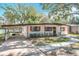 A cozy single-story home featuring a convenient carport and landscaped front yard at 213 James Dr, Winter Garden, FL 34787