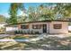 Well-kept single-story home with brick walkway, manicured landscaping, and a carport at 213 James Dr, Winter Garden, FL 34787