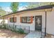 Inviting front entrance featuring a stylish black door and orange decorative shutters at 213 James Dr, Winter Garden, FL 34787