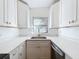 A well-lit kitchen with white countertops and cabinets with gold hardware at 213 James Dr, Winter Garden, FL 34787