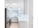 A well-lit kitchen featuring white cabinets, countertops, and stainless steel appliances at 213 James Dr, Winter Garden, FL 34787