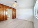 Bright living room with wood paneling, a ceiling fan, and an open view to the kitchen at 213 James Dr, Winter Garden, FL 34787