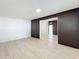 A spacious living room with modern wood-look flooring and accent wall at 213 James Dr, Winter Garden, FL 34787