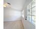 Inviting living room featuring light-filled windows and a welcoming front door entrance at 213 James Dr, Winter Garden, FL 34787