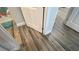 Bathroom featuring wood-look tile flooring and a white door at 2132 Limestone Trl, Kissimmee, FL 34747