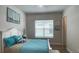 Serene bedroom with nautical decor, plush bedding, and lots of natural light at 2132 Limestone Trl, Kissimmee, FL 34747