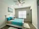 Bedroom boasting a coastal theme, ceiling fan, and beautiful wood-look tile floors at 2132 Limestone Trl, Kissimmee, FL 34747