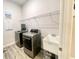 Functional laundry room with modern appliances, sink, and storage at 2132 Limestone Trl, Kissimmee, FL 34747