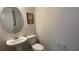 Charming powder room with pedestal sink and whimsical wall decor at 2132 Limestone Trl, Kissimmee, FL 34747