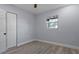 This bedroom features light gray walls, a window, wood flooring, and a closet at 25 N Van Buren Ave, Orlando, FL 32811