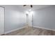 Clean bedroom featuring light gray walls, wood-look flooring, and a white closet door at 25 N Van Buren Ave, Orlando, FL 32811