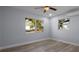 Serene bedroom featuring wood-look floors, light gray walls, and natural light at 25 N Van Buren Ave, Orlando, FL 32811